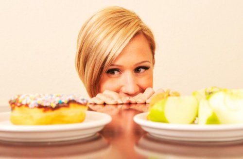 Женщина наблюдает за печеньем, стресс может вызвать повышенный аппетит