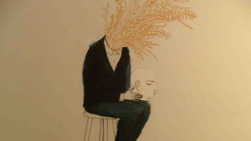 Человек с зерном, растущим с шеи, держит голову на коленях